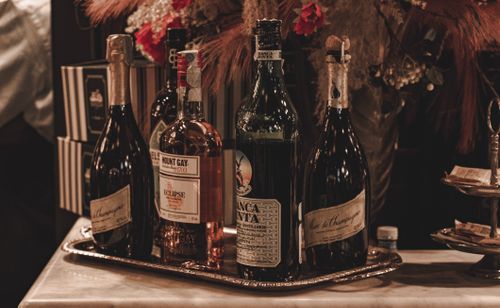 Free A sophisticated arrangement of premium wines and spirits at a bar in Milan, Italy, showcasing luxurious bottles in a warm setting. Stock Photo
