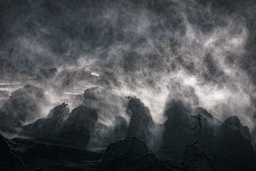 Ethereal winter landscape with dramatic snow and mist in Auvergne-Rhône-Alpes, France.