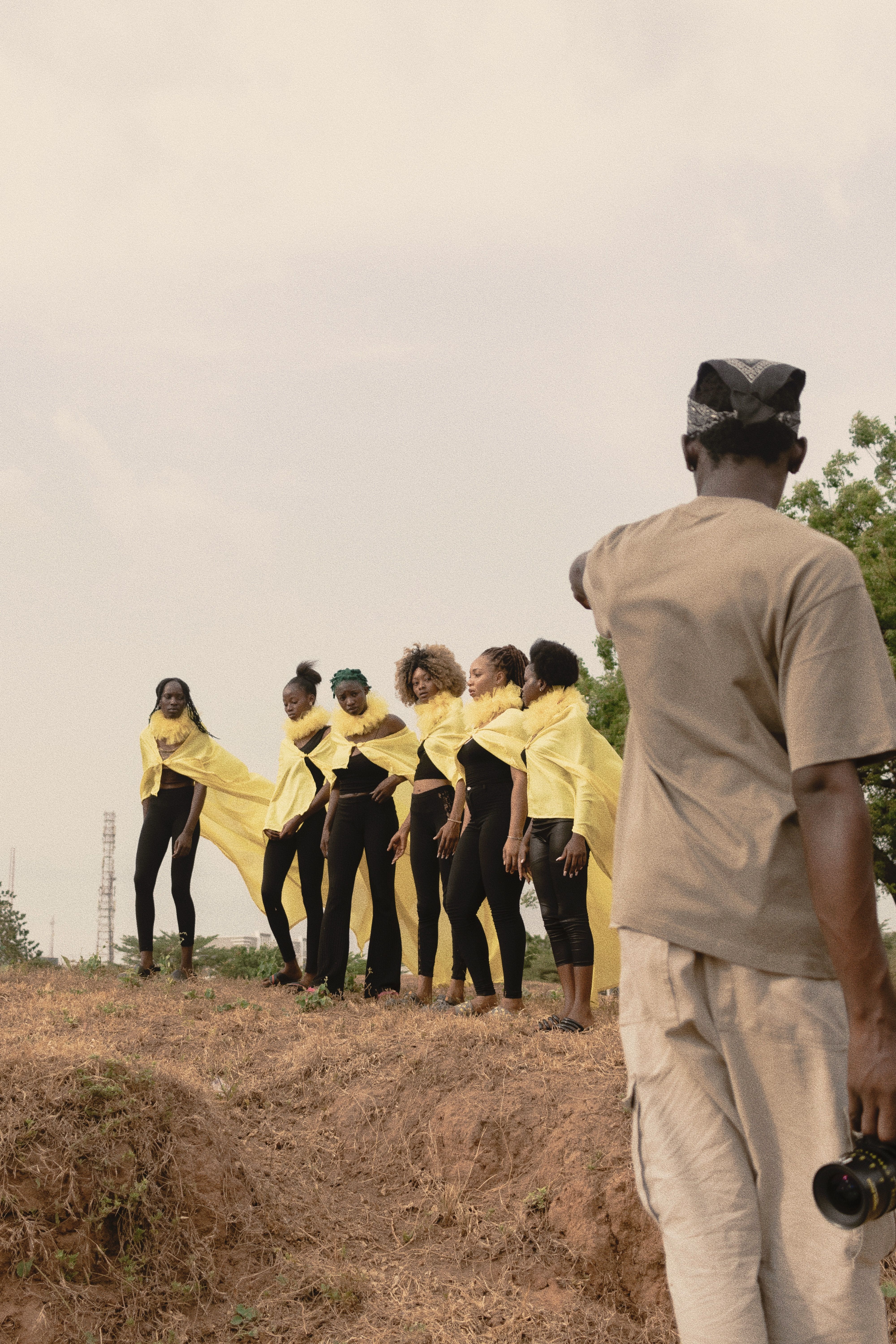Behind-the-scenes look at an outdoor fashion shoot in Nigeria with diverse models.