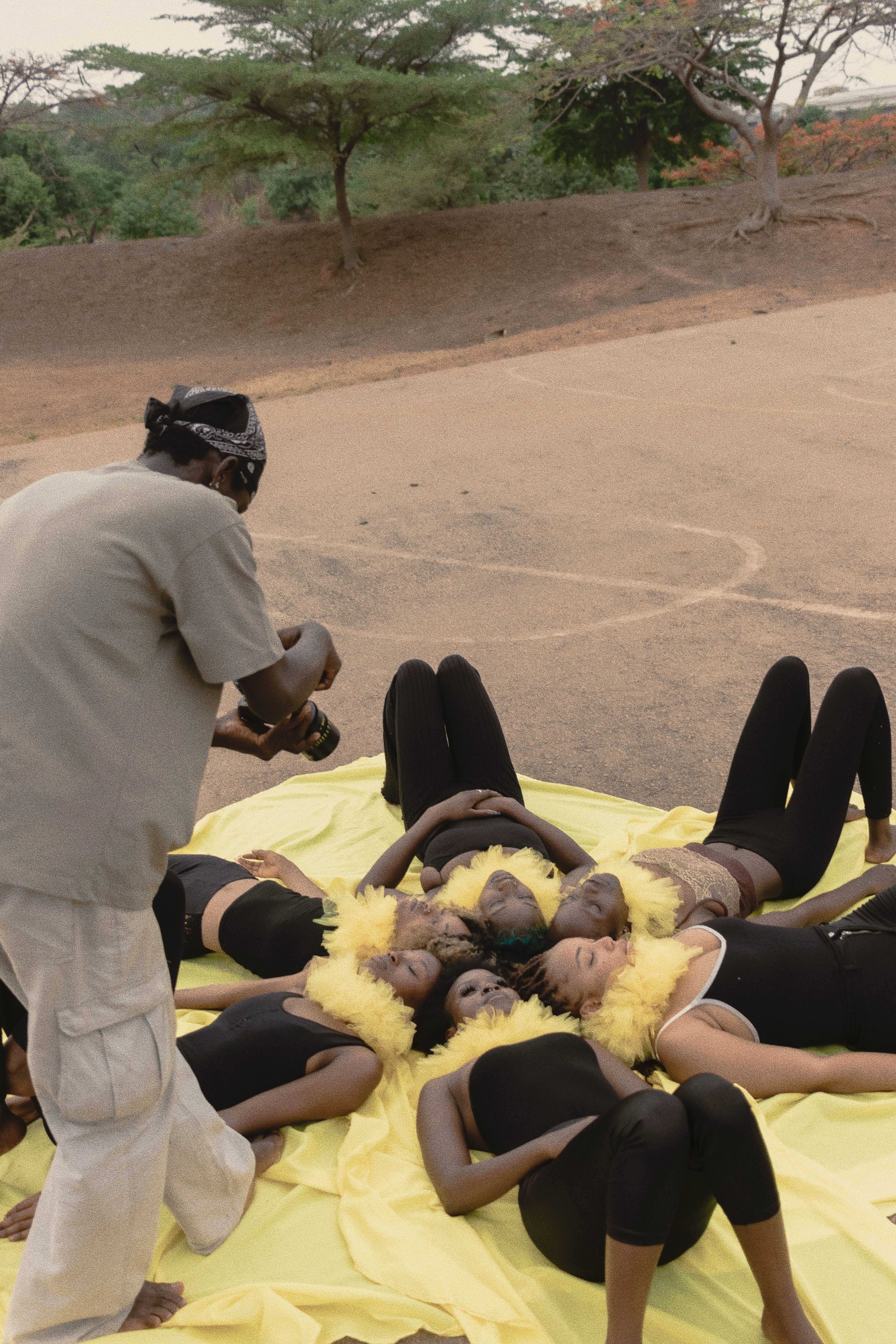 A photographer captures a creative outdoor group setup with models in Abuja.