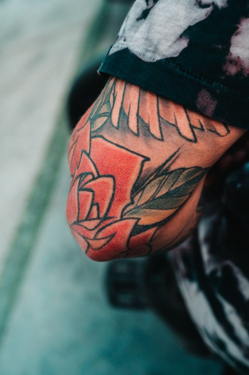 Free A detailed view of a colorful floral tattoo on an arm, showcasing artistic design. Stock Photo