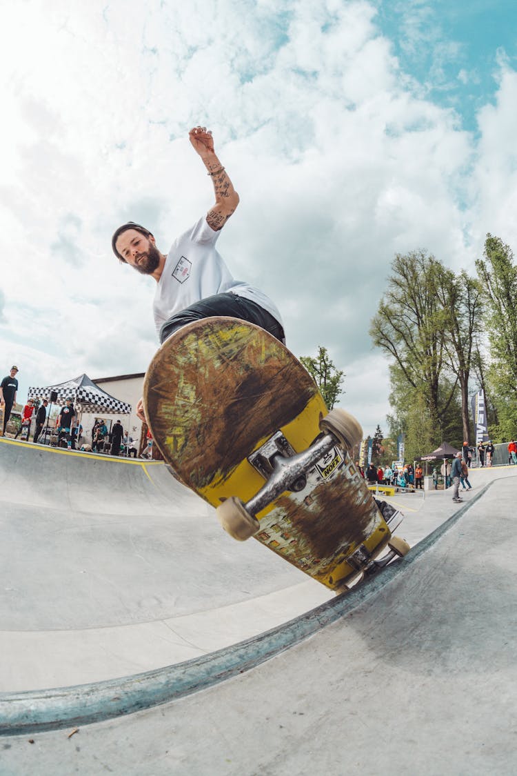 Man Playing Skateboard On Ramp