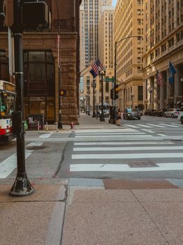 Chicago downtown street with skyscrapers, a bus, and city life.