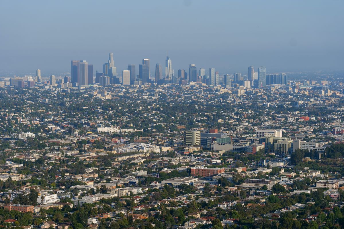 Aerial view of the downtown Los Angeles skyline under a clear blue sky