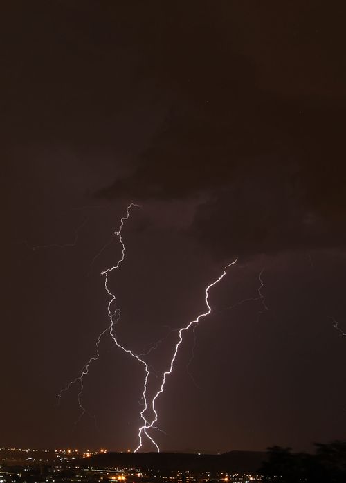 Free Electrifying night sky with striking lightning over Johannesburg cityscape. Stock Photo