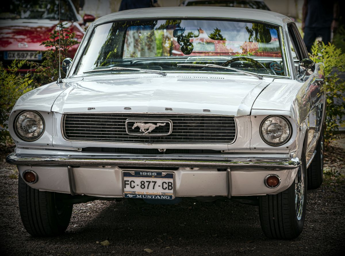 Front view of an iconic classic white 1966 Ford Mustang