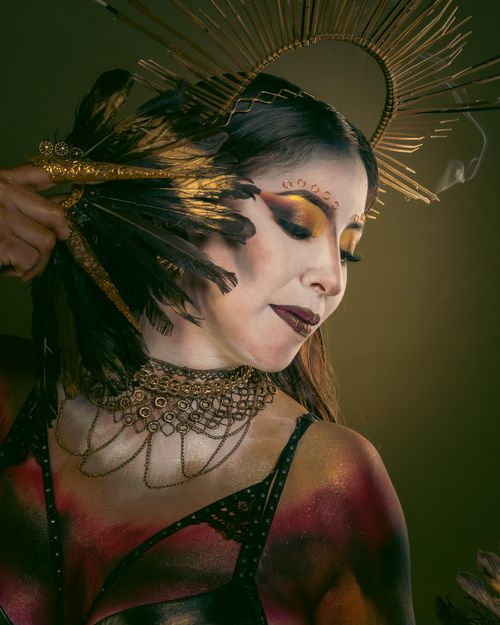 Free Portrait of a Latin dancer in Mexico City with a stunning feather headdress and artistic makeup. Stock Photo