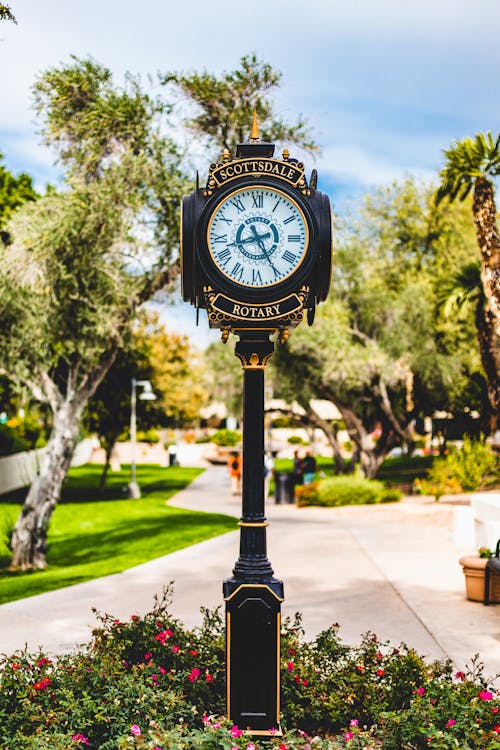A Vintage Clock In The Middle Of A Park