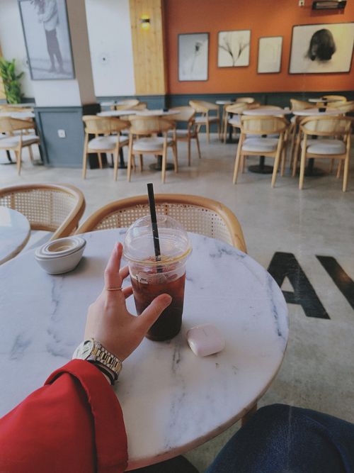 Free Relax in a modern Gebze cafe with an iced coffee and stylish decor. Stock Photo
