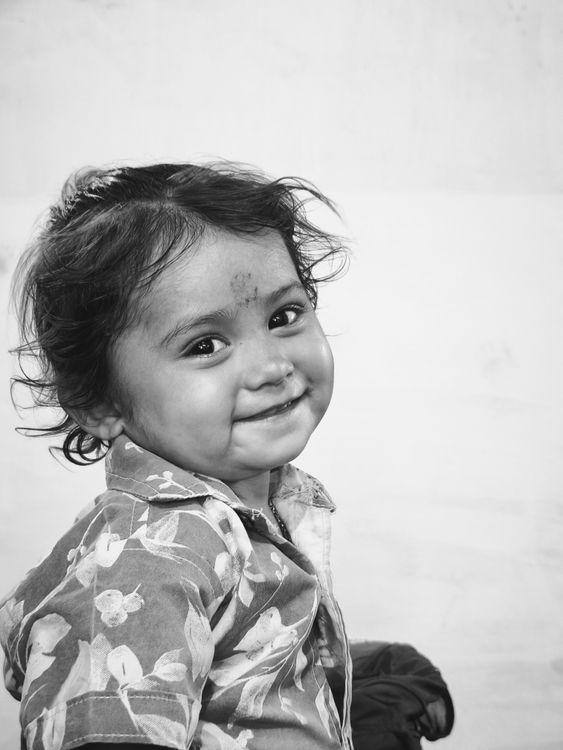 Charming Black and White Portrait of a Smiling Child · Free Stock Photo