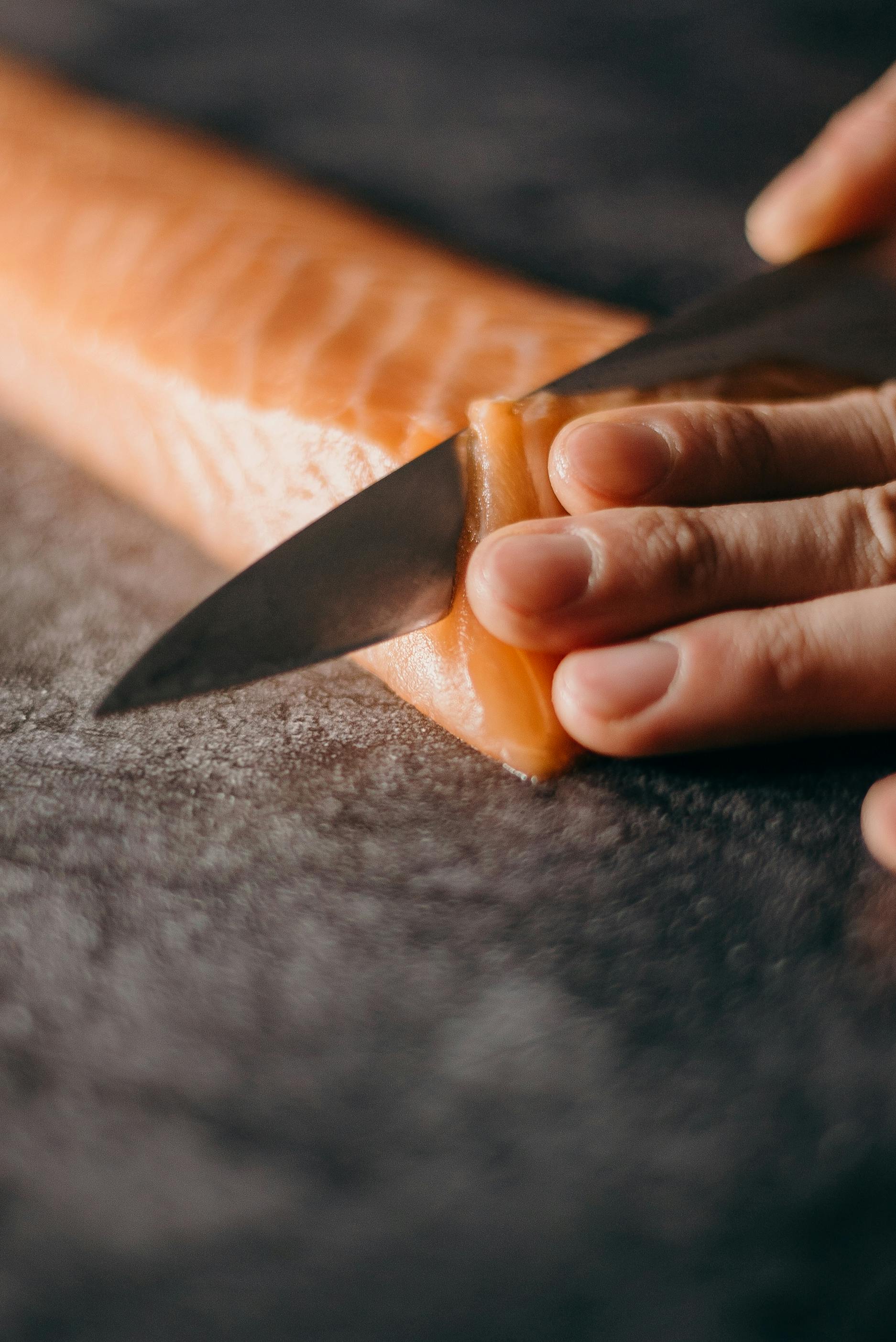 Photo Of Person Slicing Salmon · Free Stock Photo