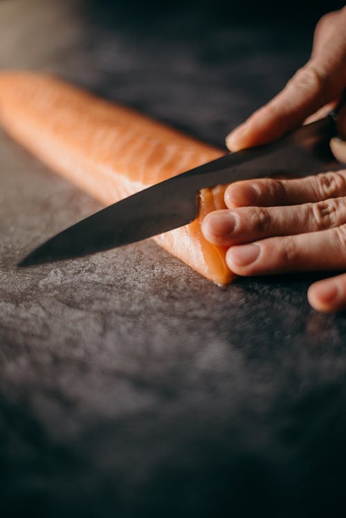 Photo Of Person Slicing Salmon 