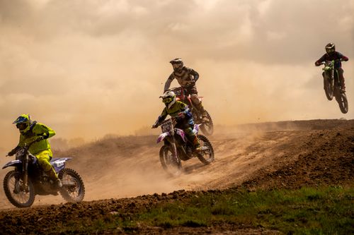 Free Dynamic motocross race with riders in action on a dirt track, showcasing speed and competition. Stock Photo