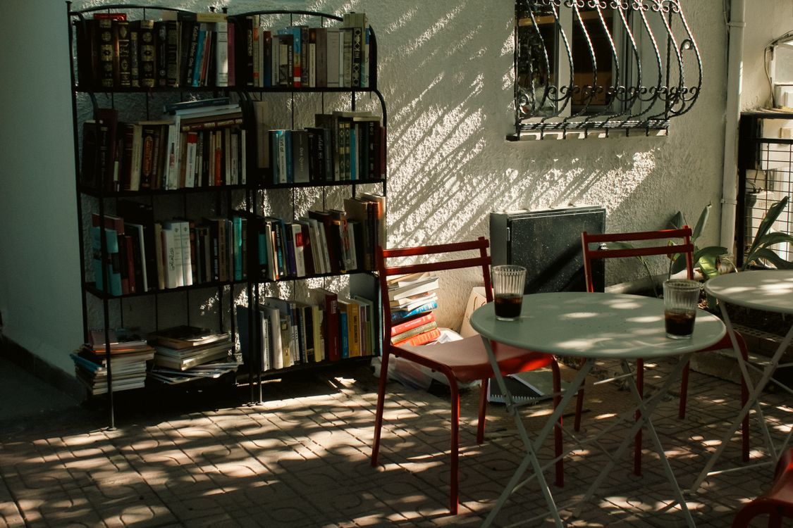 Cozy Outdoor Reading Space with Books and Chairs · Free Stock Photo
