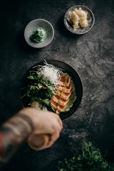 A top-down view of a chef preparing sashimi with fresh ingredients, showcasing authentic Japanese cuisine.