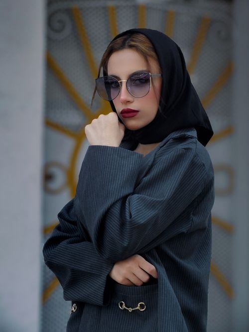 Free Stylish woman in sunglasses and black hijab, exuding elegance and modern fashion. Stock Photo