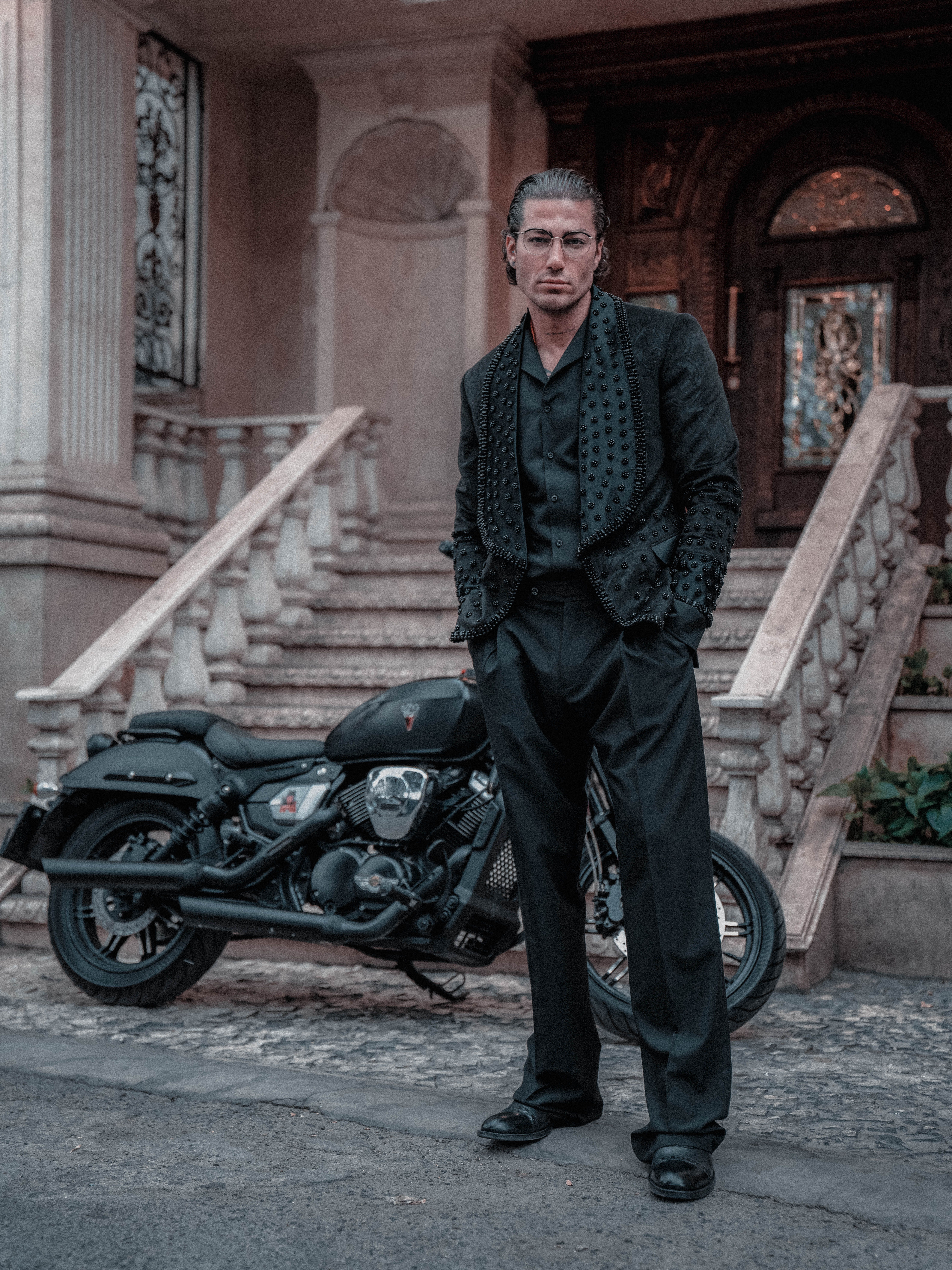 Confident Man Posing by Motorcycle