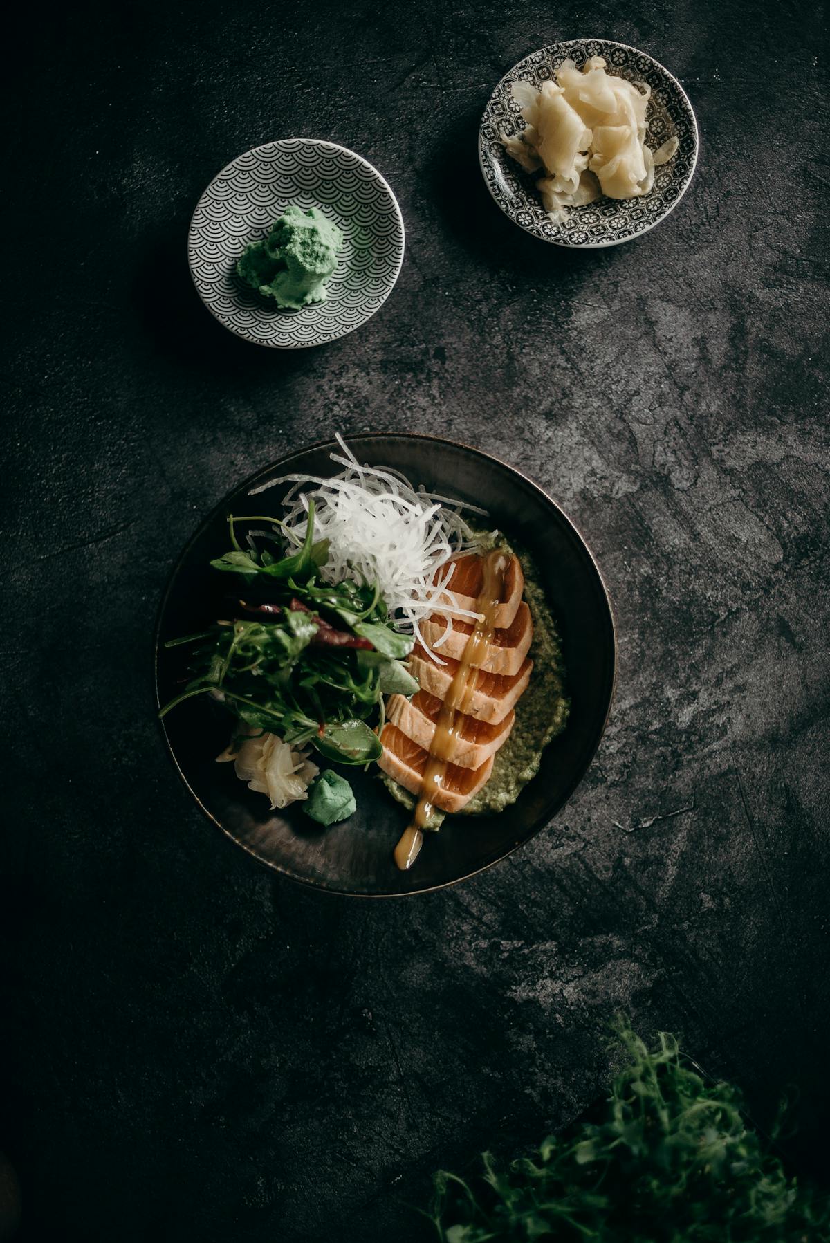 Person journaling with a healthy snack and tea to track fasting and energy