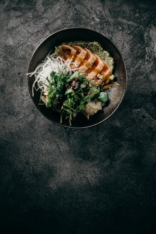 Sliced Meat With Green Vegetable on Stainless Steel Round Plate