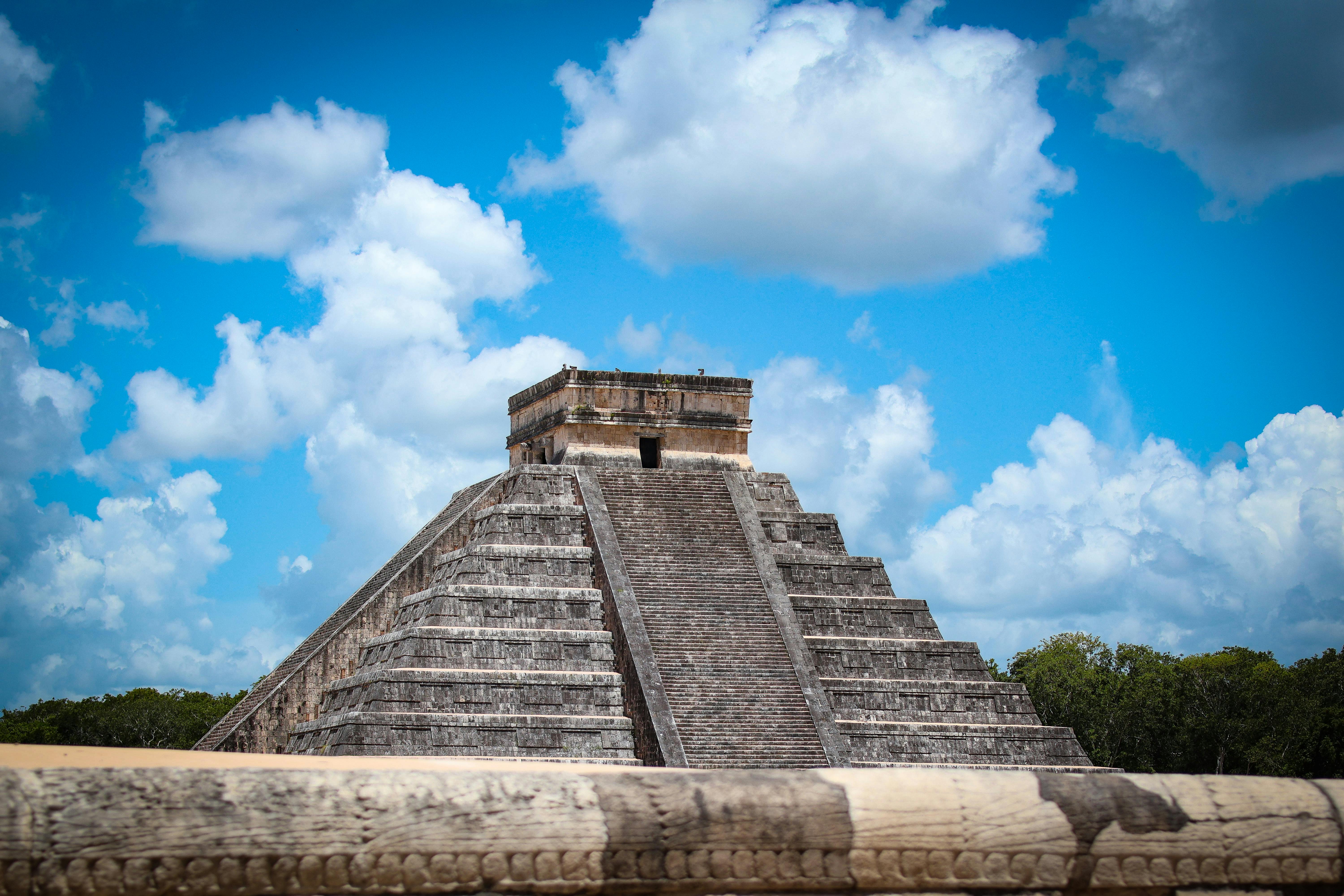 best time of year to visit mayan ruins - Explore the ancient beauty of the Pyramid of Chichén Itzá against a vibrant blue sky in Yucatán, Mexico.