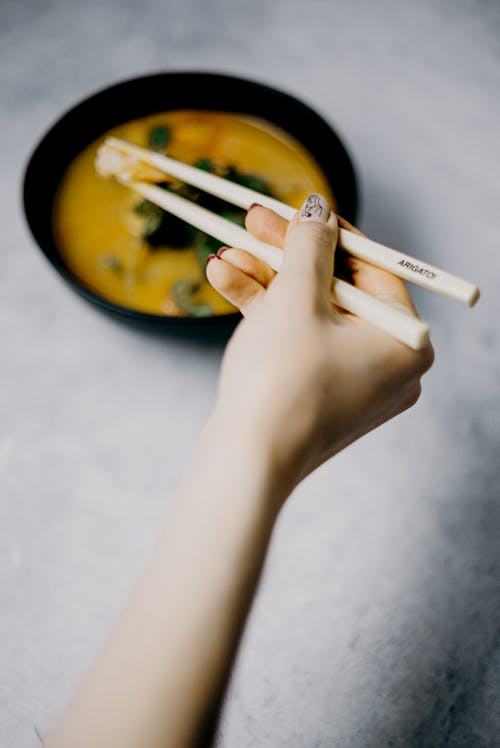 Photo Of Person Holding Chopsticks