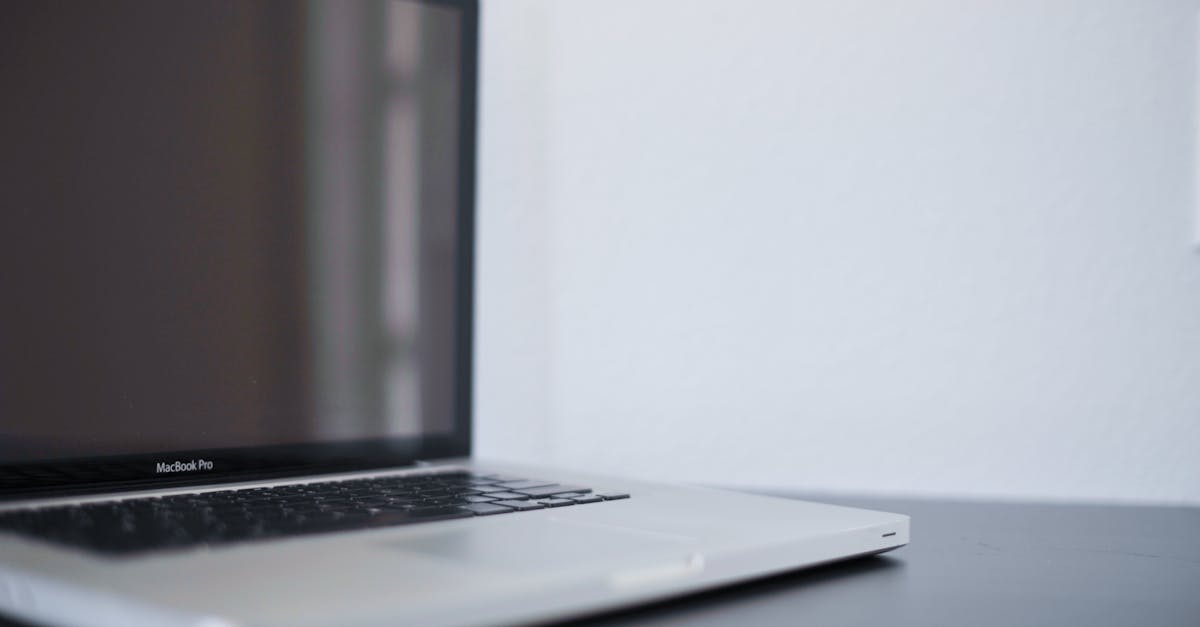Photo by Janine Speidel A sleek silver laptop on a modern desk against a white backdrop, perfect for work settings.