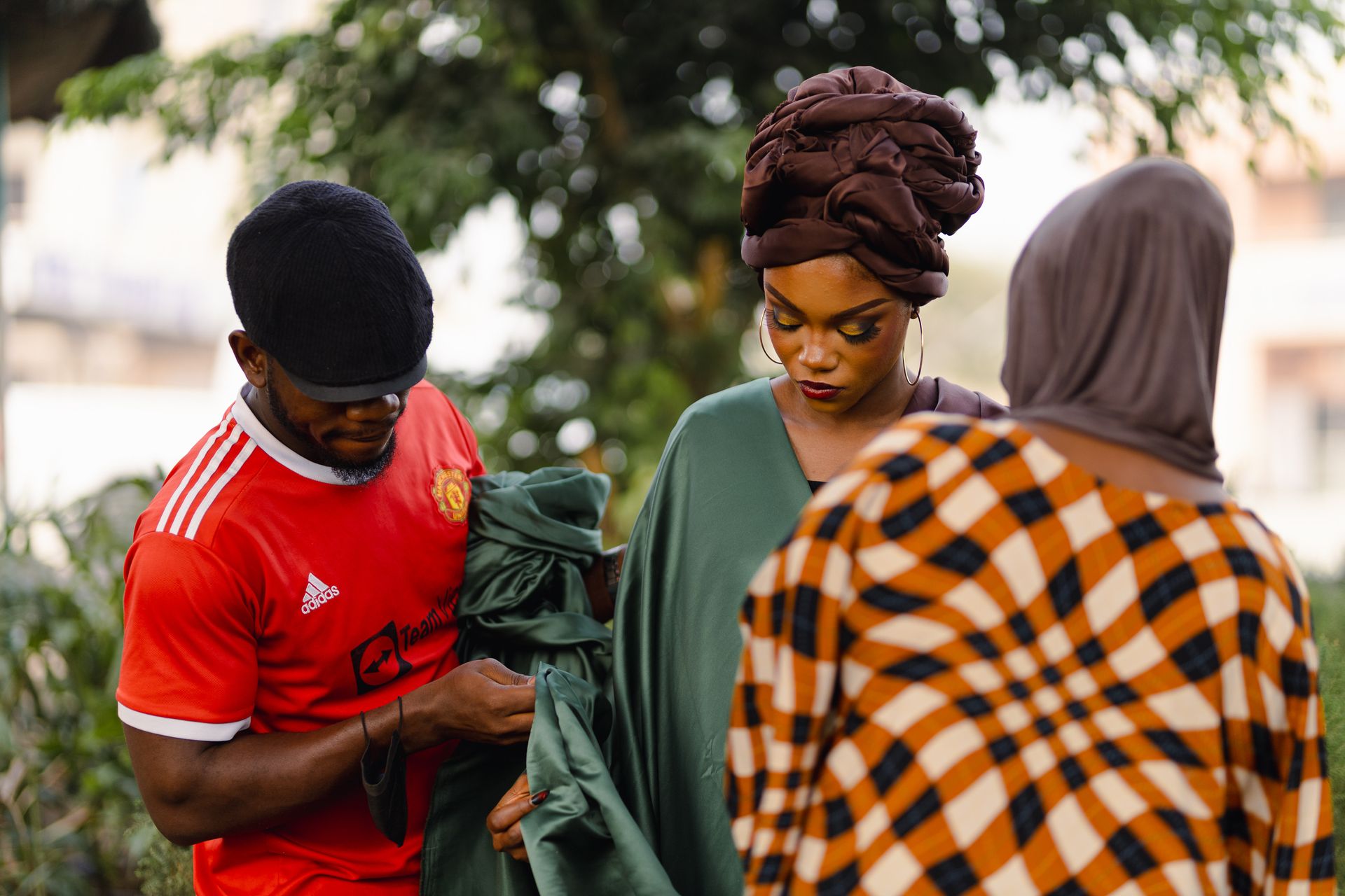 A stylish group wearing vibrant clothing outdoors, showcasing modern cultural fashion.