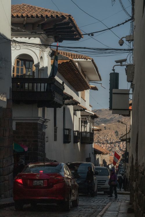 Free Discover the vibrant architecture and cultural ambiance of a historic street in Cusco, Perú. Stock Photo