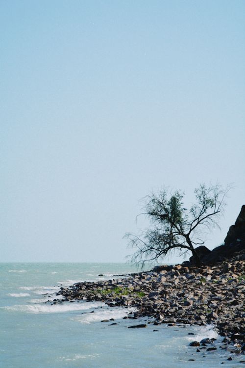 Free Peaceful coastal scene at Lake Balkhash with rocky shore and clear sky. Stock Photo