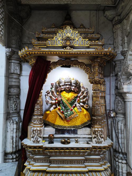 Free Ornate sculpture of a Hindu deity with multiple arms in a decorated temple alcove. Stock Photo