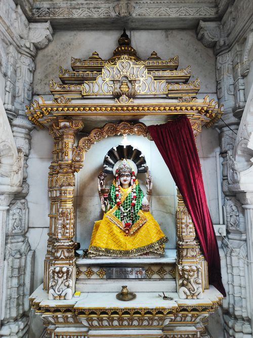 Free Beautiful stone-carved altar with Hindu deity statue in temple setting. Stock Photo
