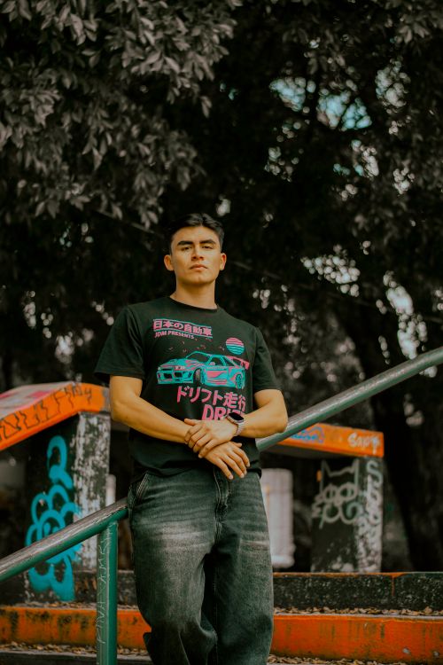 Free Confident young man stands in a graffiti-covered park, embodying urban fashion and street culture. Stock Photo