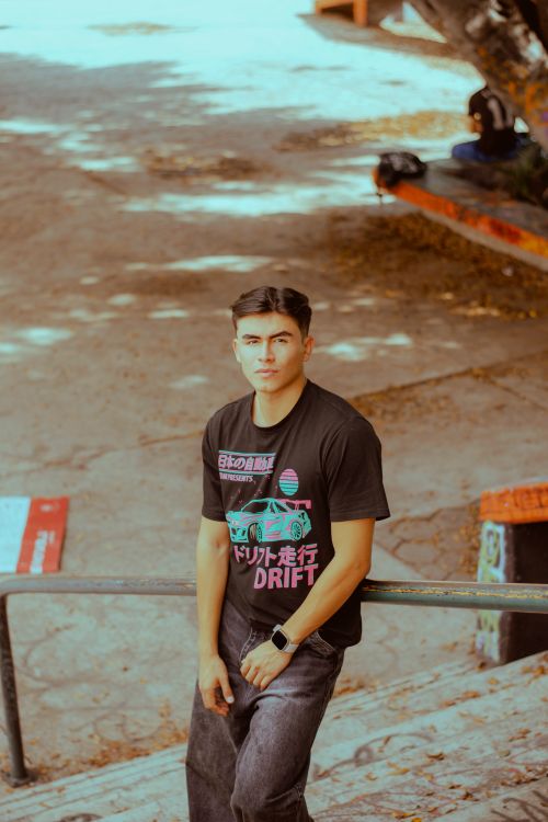 Free Casual portrait of a young man at a skatepark, wearing a graphic tee and looking at the camera. Stock Photo