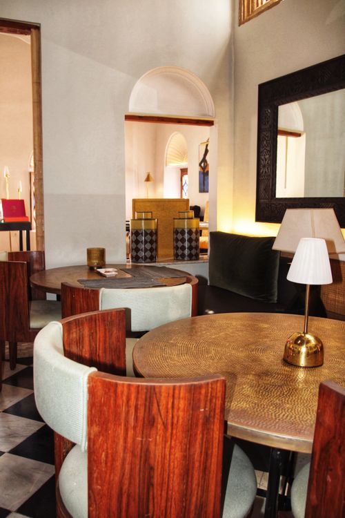 Free Stylish dining room with wooden furniture and ambient lighting, creating a cozy and inviting atmosphere. Stock Photo