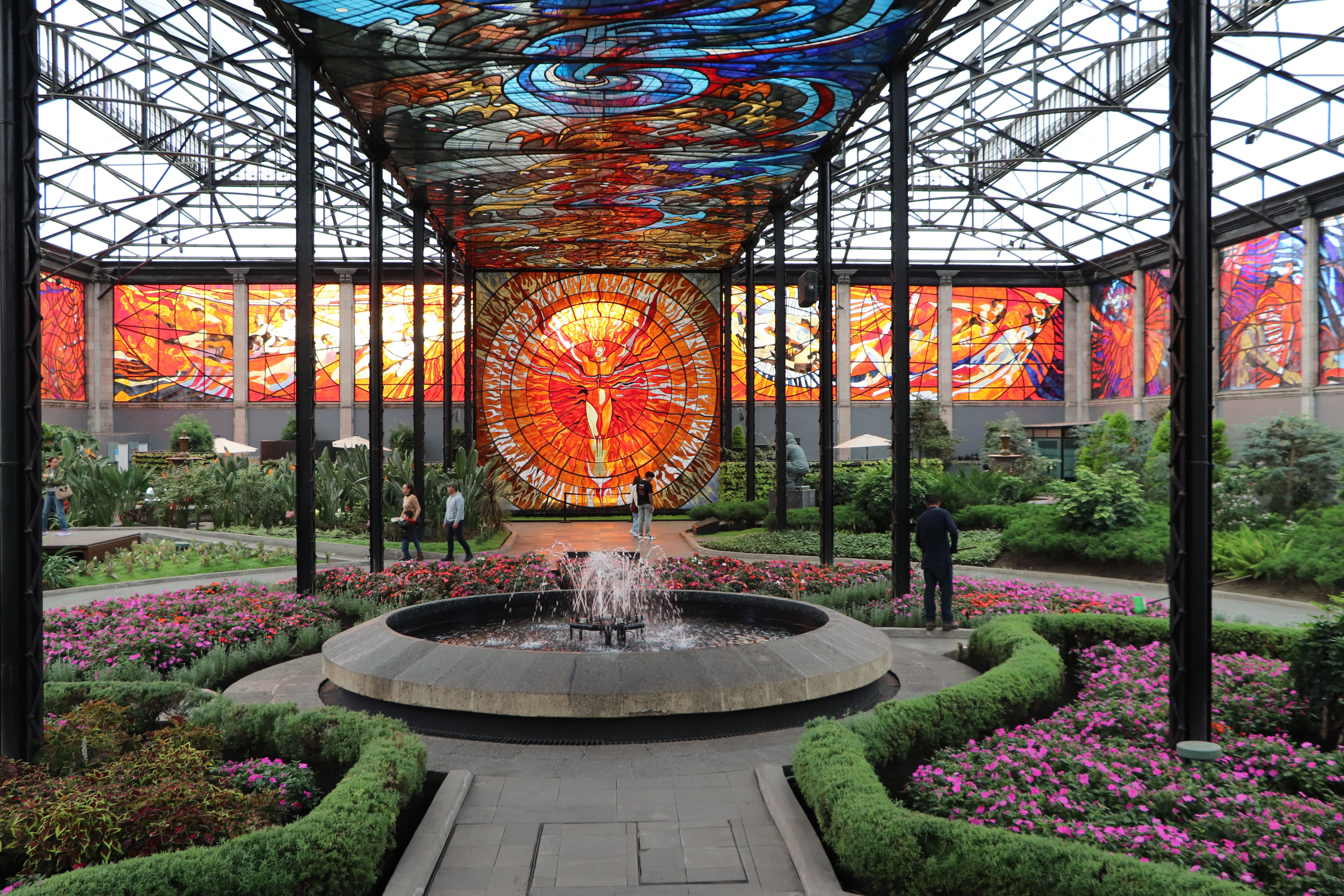 Vibrant stained glass and lush gardens at Cosmovitral, Toluca.