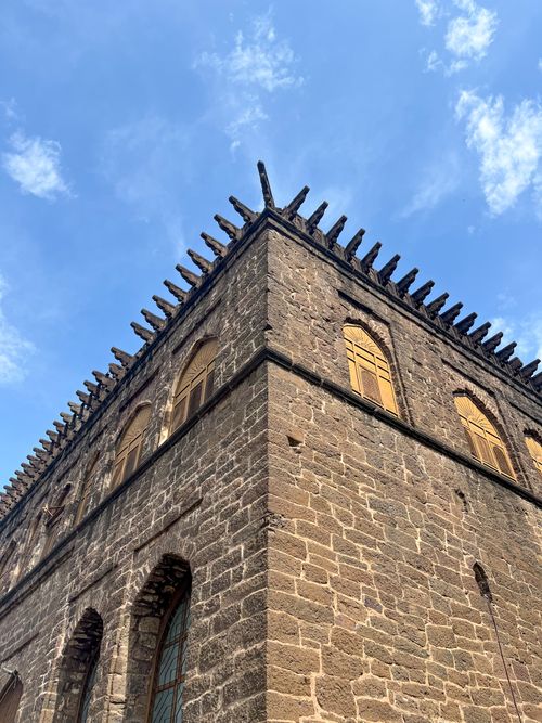 Free Explore the rich architectural heritage of a historic stone building in Vijayapura, India under a bright blue sky. Stock Photo