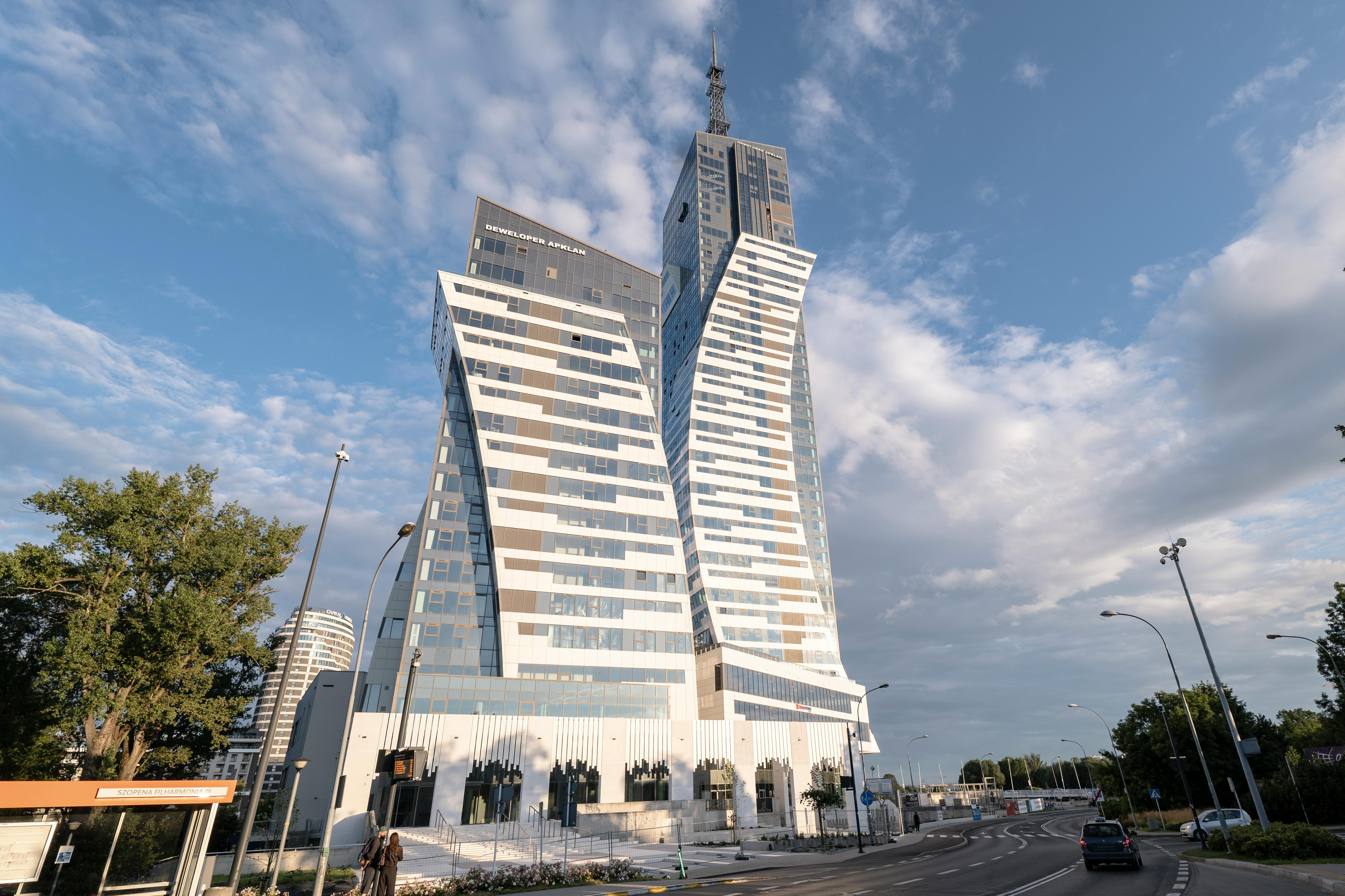 Striking modern architecture of a skyscraper in Rzeszów against a summer sky.