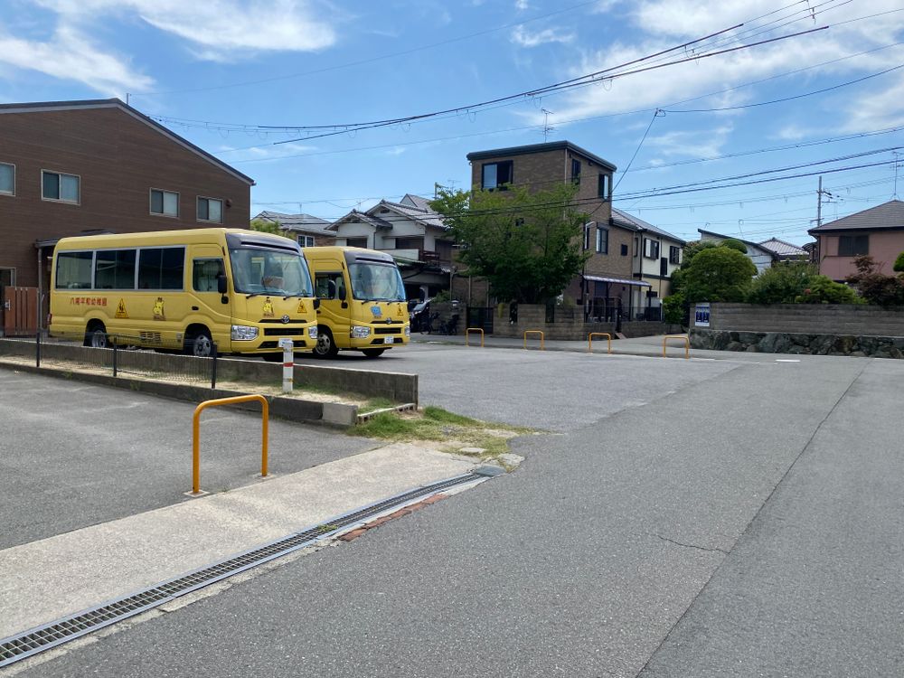 Japanese residential area with houses and vehicles on a sunny day