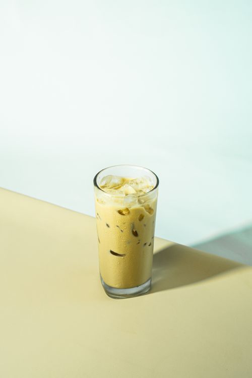 Free A chilled glass of iced coffee with a minimalist background, perfect for beverage lovers. Stock Photo