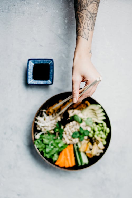 Photo Of Person Holding Chopsticks