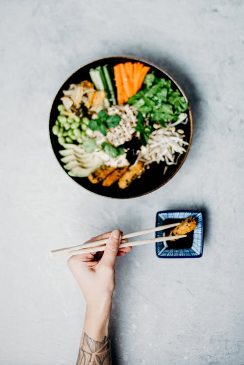 Free Photo Of Person Holding Chopsticks Stock Photo