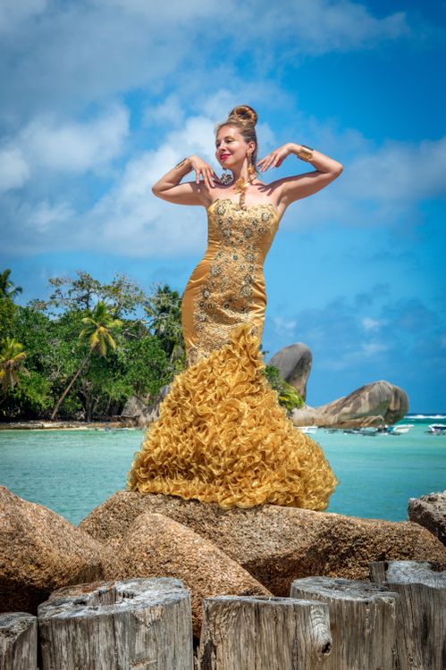 Elegant Woman in Golden Gown by Beach  Free Stock Photo