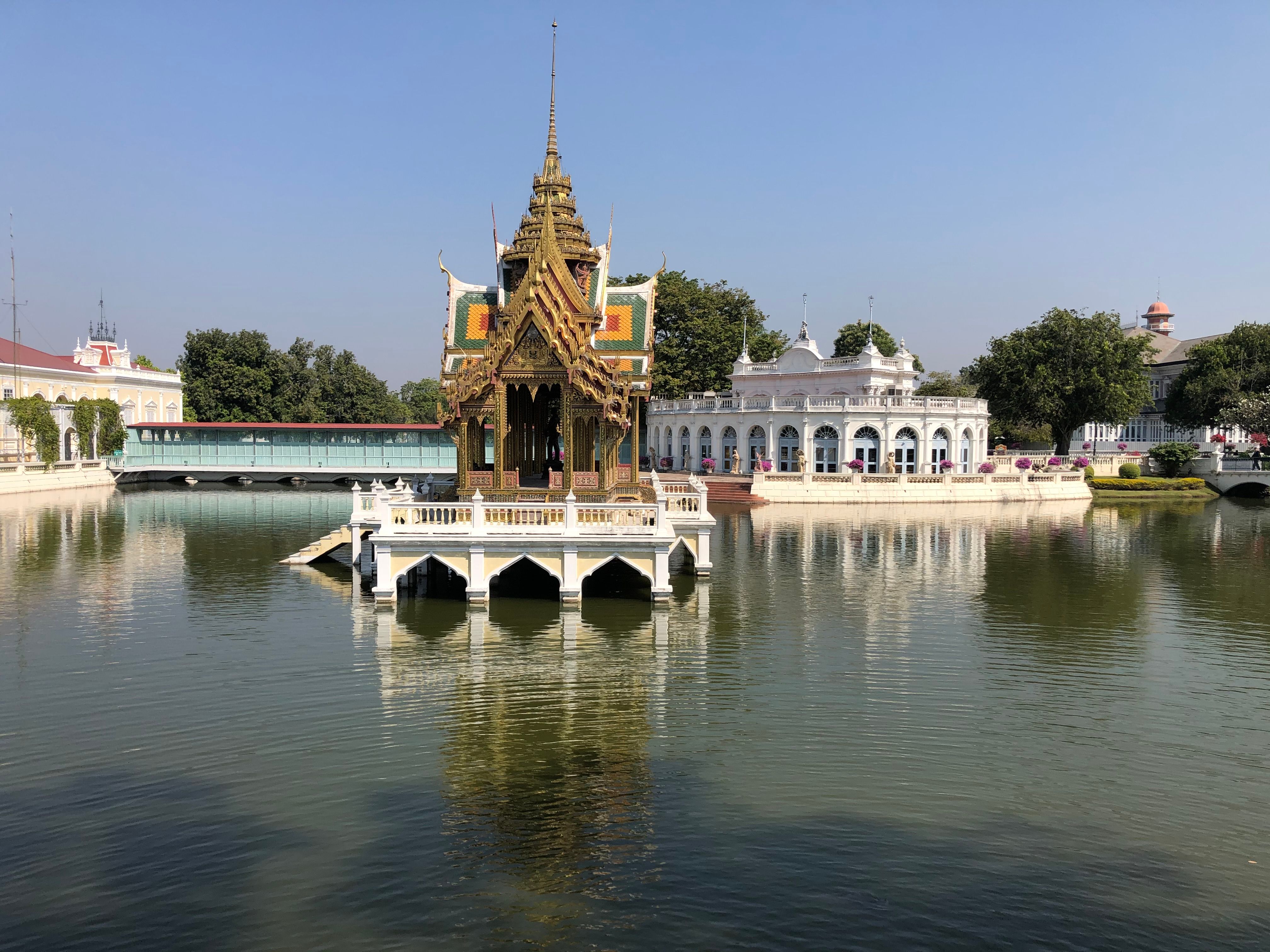 A picturesque view of the unique pavilion at Bang Pa-In Royal Palace with reflections in the water.