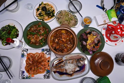 Free Diverse Asian meal with shrimp, fish, and vegetables on a table setting. Stock Photo