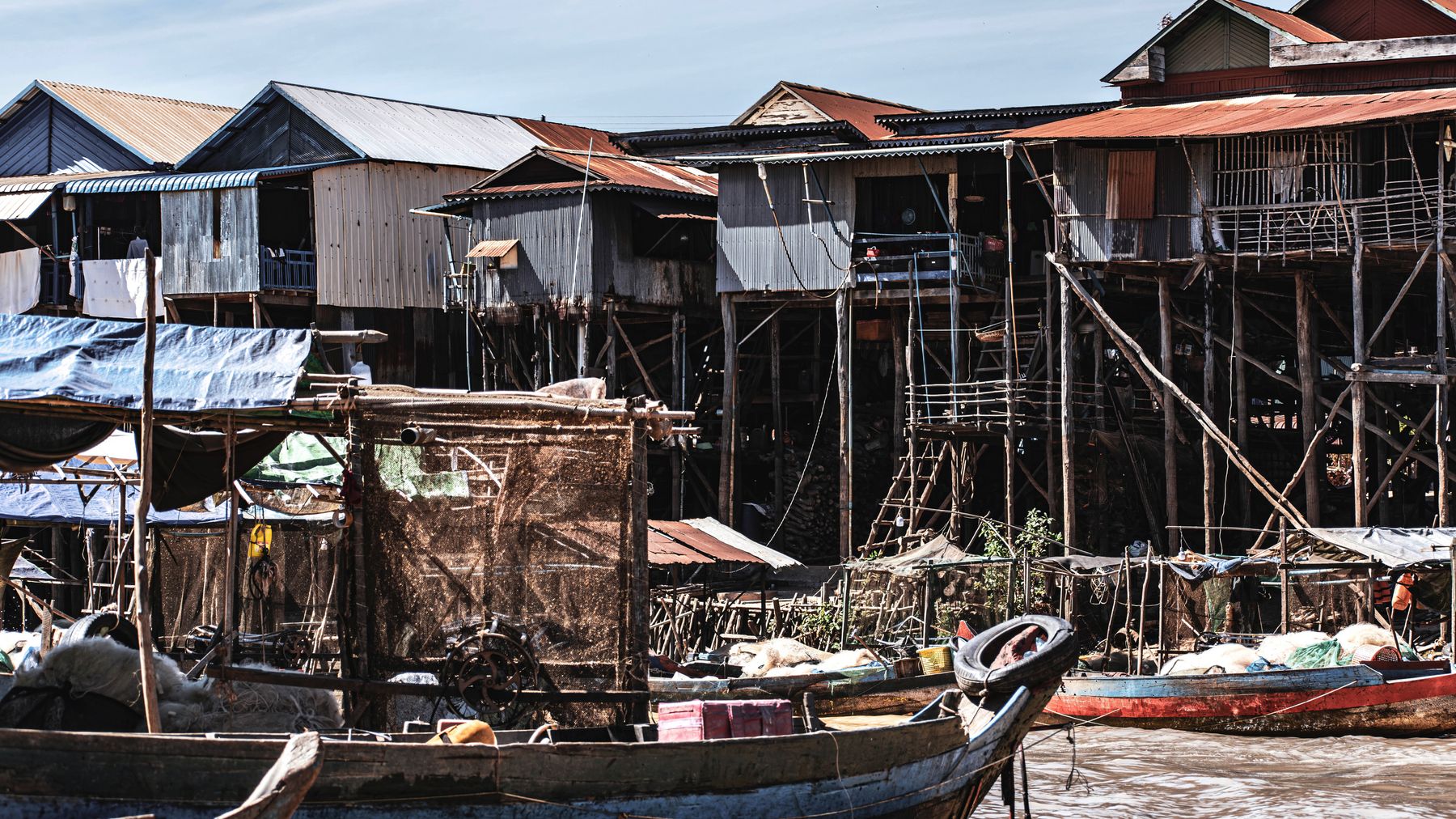 Traditional stilt houses in Kampong Phluk, Cambodia, showcasing unique riverfront architecture.