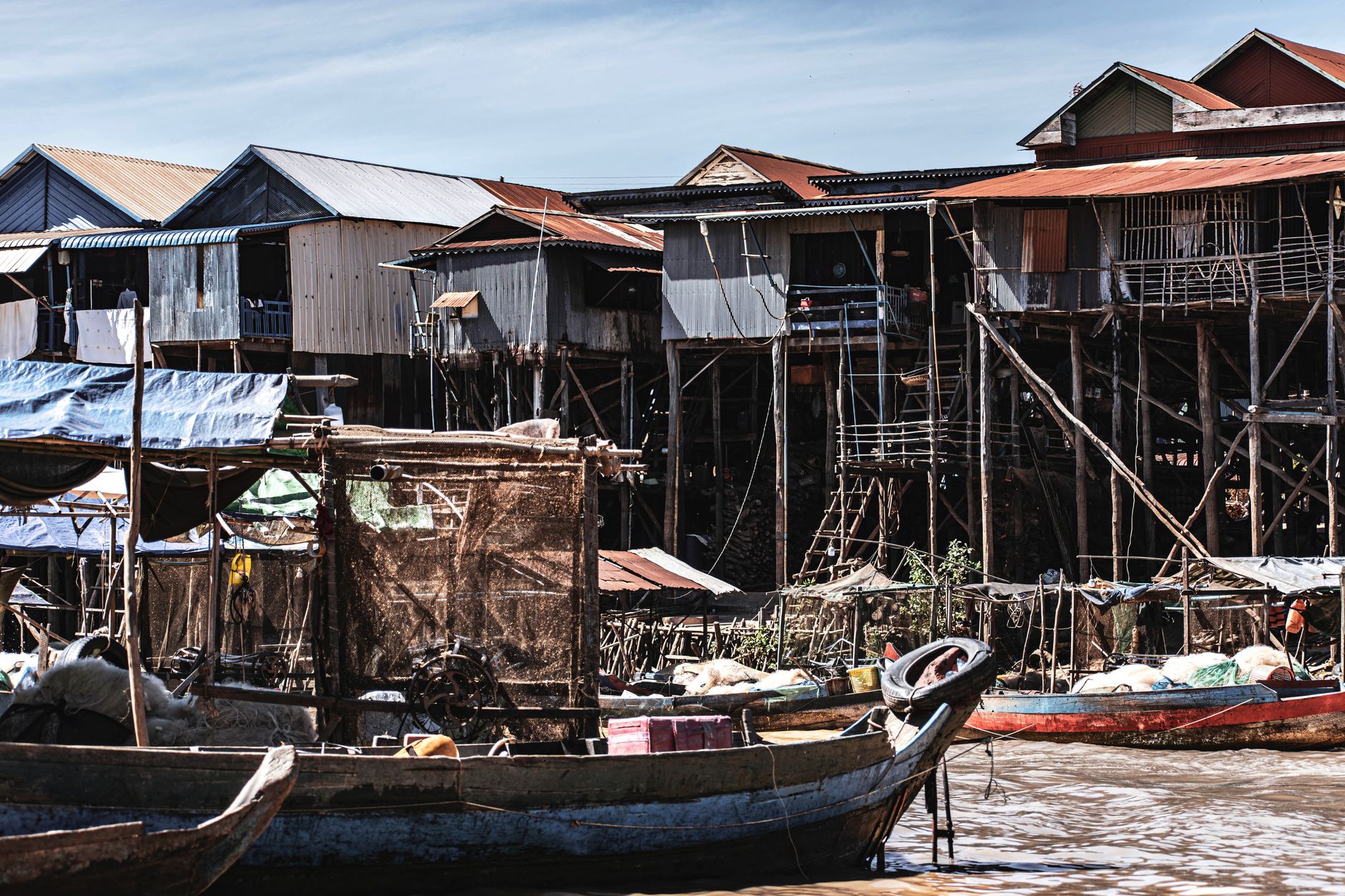 Traditional stilt houses in Kampong Phluk, Cambodia, showcasing unique riverfront architecture.