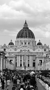 Monochrome image showcasing the iconic St. Peter's Basilica and bustling crowd.