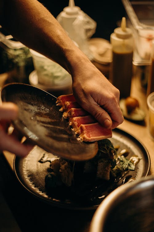 Photo Of Man Holding Sushi 