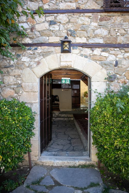 Free Inviting stone archway entrance to a historic Turkish building framed by lush greenery. Stock Photo