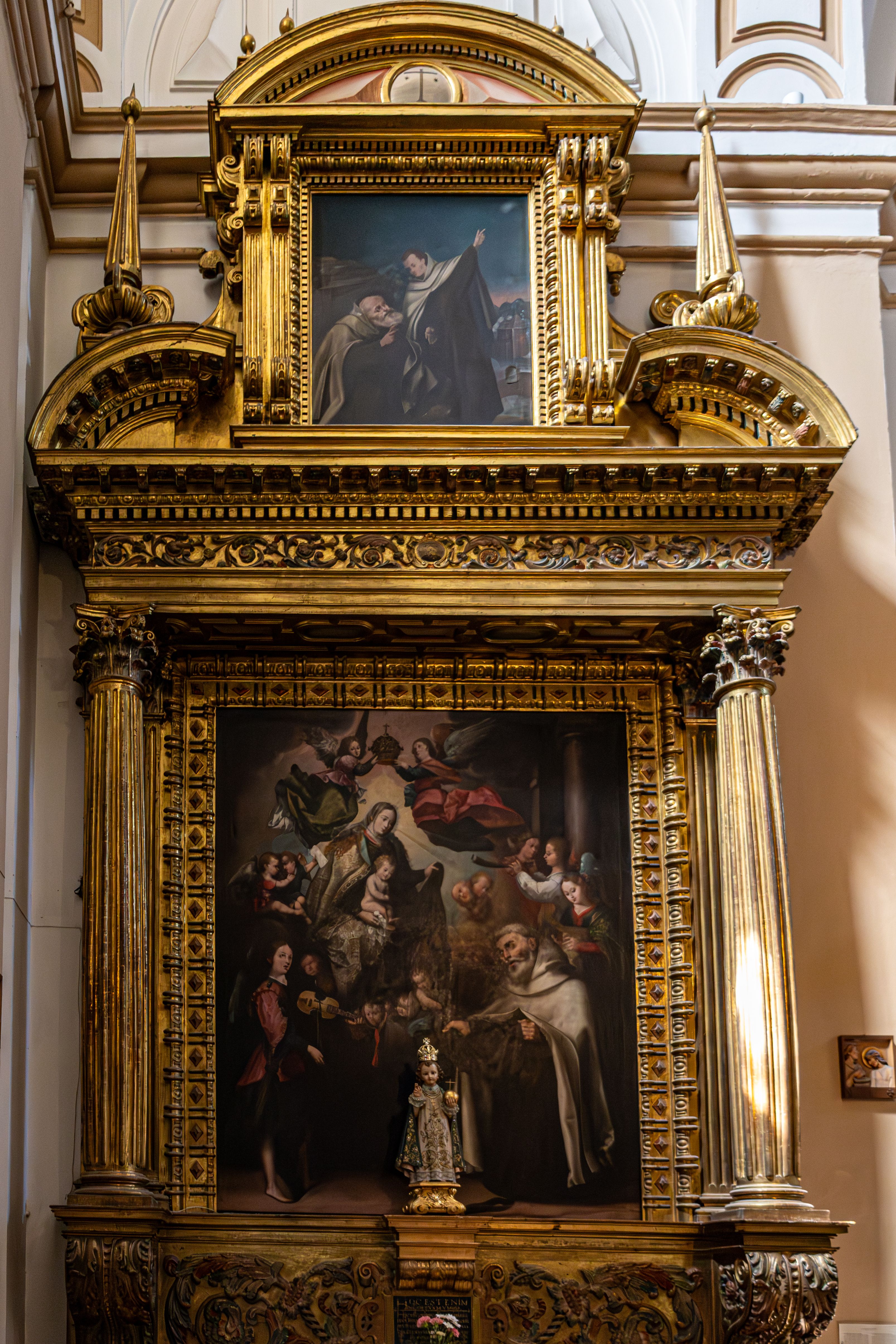 A detailed view of an ornate religious altar inside a historic church in Ávila, Spain.